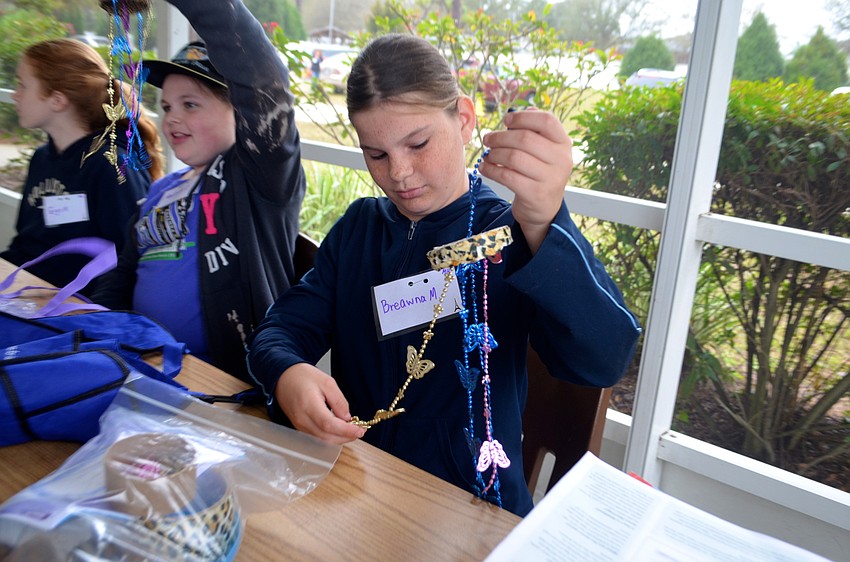 Breawna McLellen, 11, inspects her wind chime.