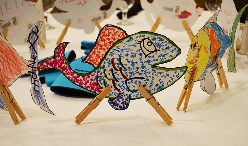 Tables were decorated with paper fish colored by children for the Suncoast Charities for Children organization Children First.