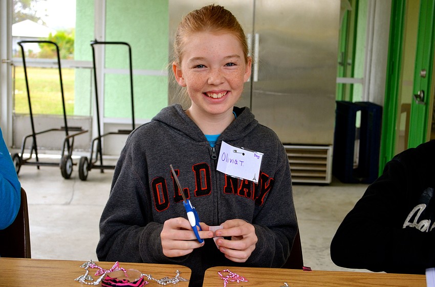 Twelve-year-old Olivia Townsend finishes her wind chime.