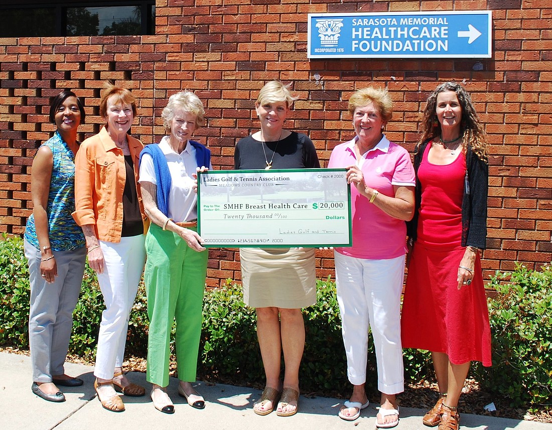 Breast Health Centerâ€™s Yulonda Greene, the Meadowsâ€™ Barb Schaal and Trish Schenck, Sarasota Memorial Healthcare Foundation CEO Alex Quarles, the Meadowsâ€™ Barbara Murray and the Breast Health Centerâ€™s Michele Young Stears celebrate the donation together.