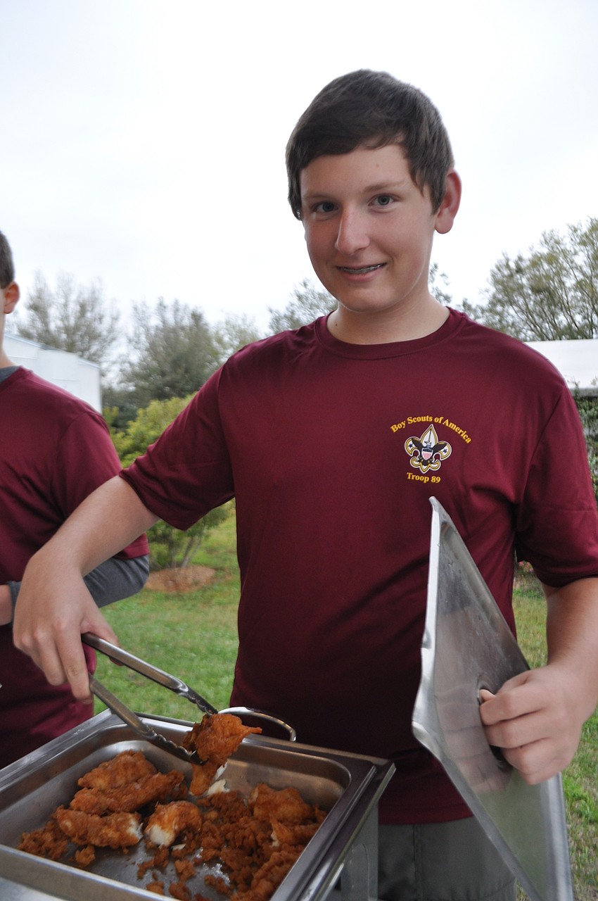 Kyle Hetzer dishes out fried fish.