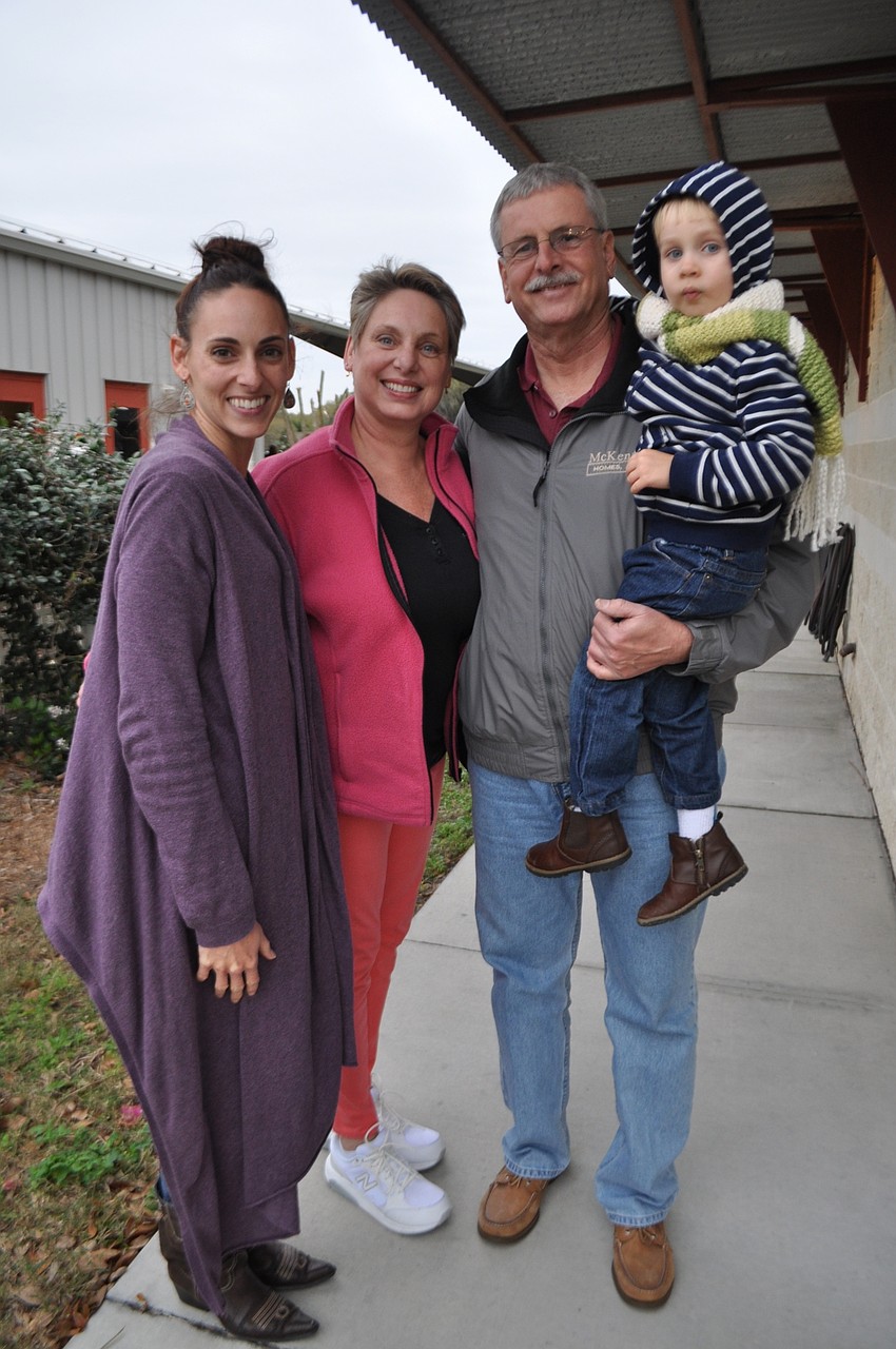 Eileen McConoughey attends with her parents, Joyce and George Dudas, and son, Ely.