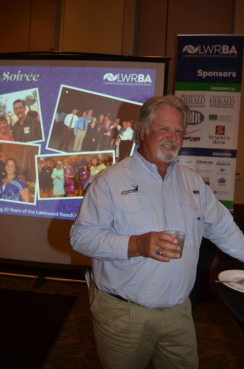John Barnott enjoys a cocktail before a buffet dinner.