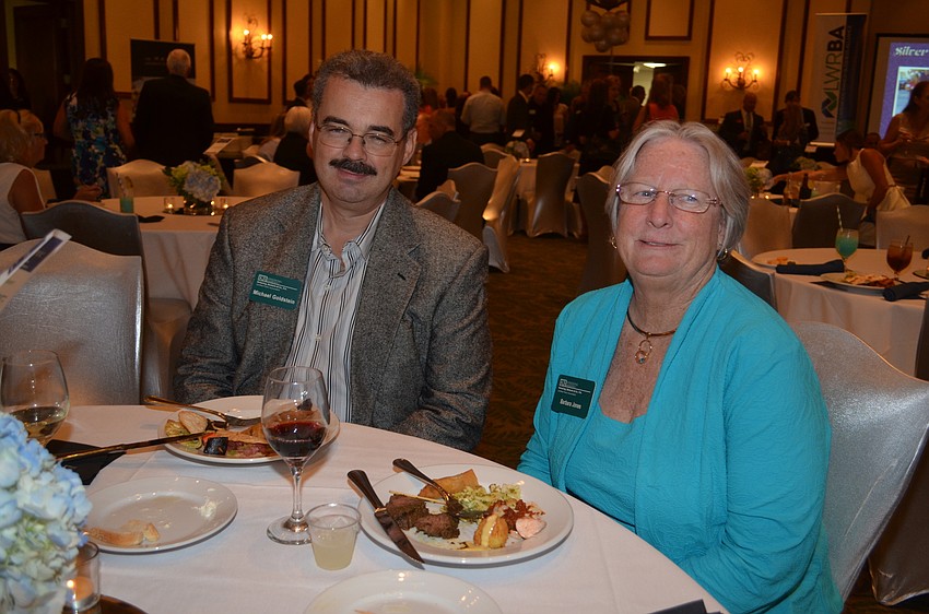 Colleagues Michael Goldstein and Barbara Jones chat over dinner.