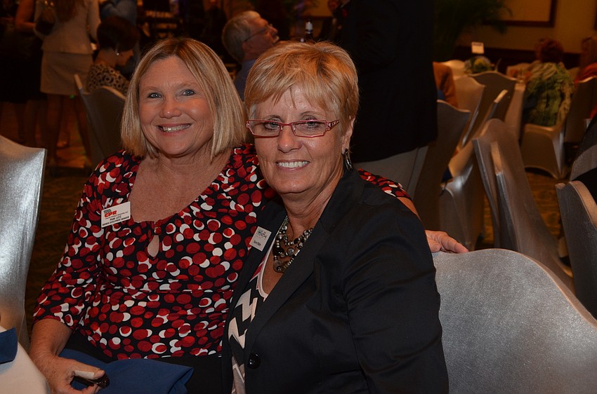 Pam Lutz and Karen Rehn share a table with friends.