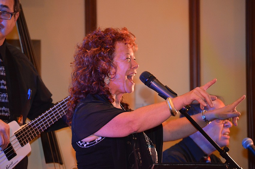 Melanie Massell leads her band in a rendition of a rock 'n' roll song.