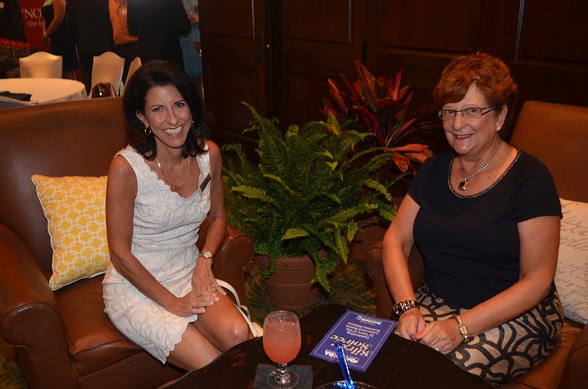 Christine Mazur and Ann Marie Marinaccio chat over cocktails.