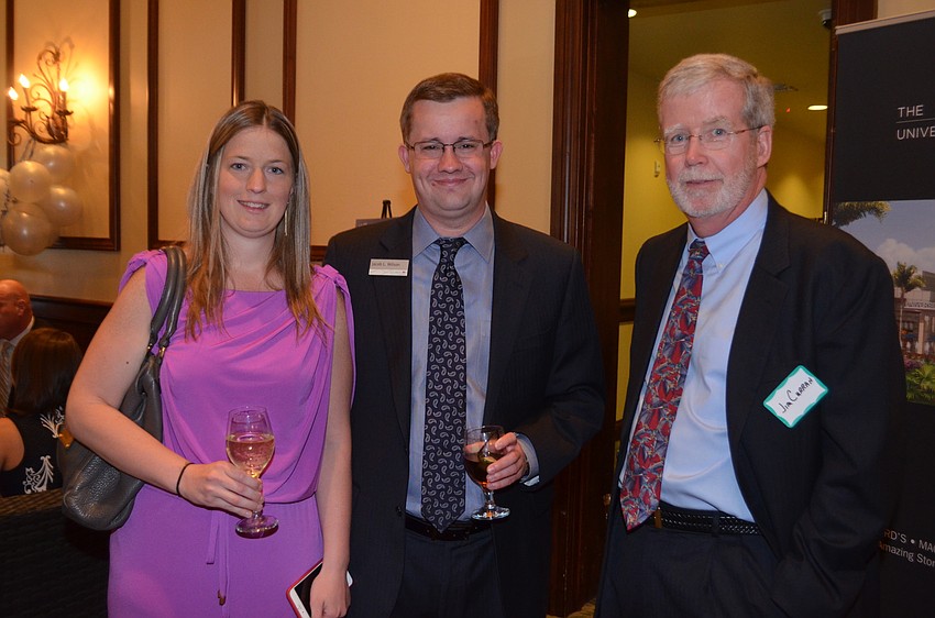 Erica Williams and Jacob Wilson mingle with attendees, such as Jim Curran.
