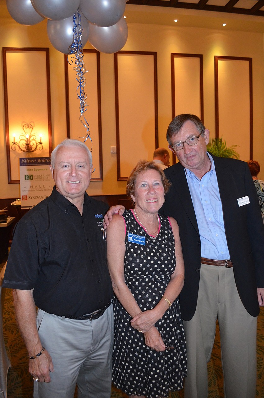 John Wojtyna says cheese with Margaret Boyd and her husband, Jim.