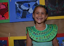 Six-year-old Isabella Andraed shows off her Egyptian-style paper necklace.