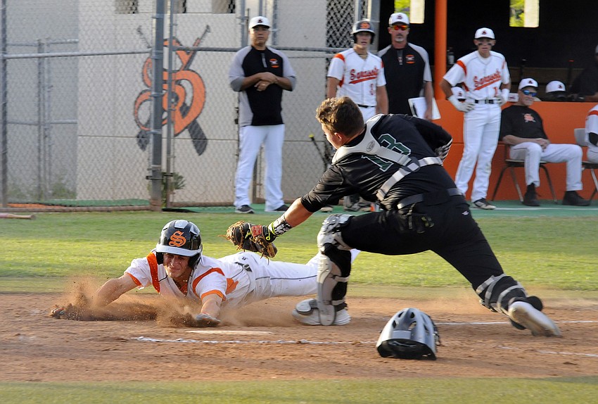 Sarasota senior Skylar Frey slides under the tag of Lakewood Ranch catcher Matt Roberts during the first inning of the Class 7A-Region 3 semifinals May 5.