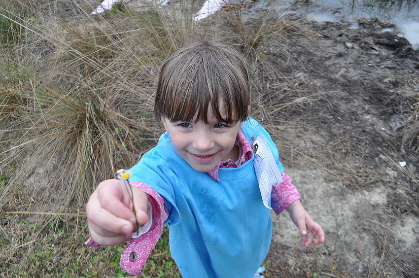 Sophia Freeman hunts for flowers after catching a bluegill.