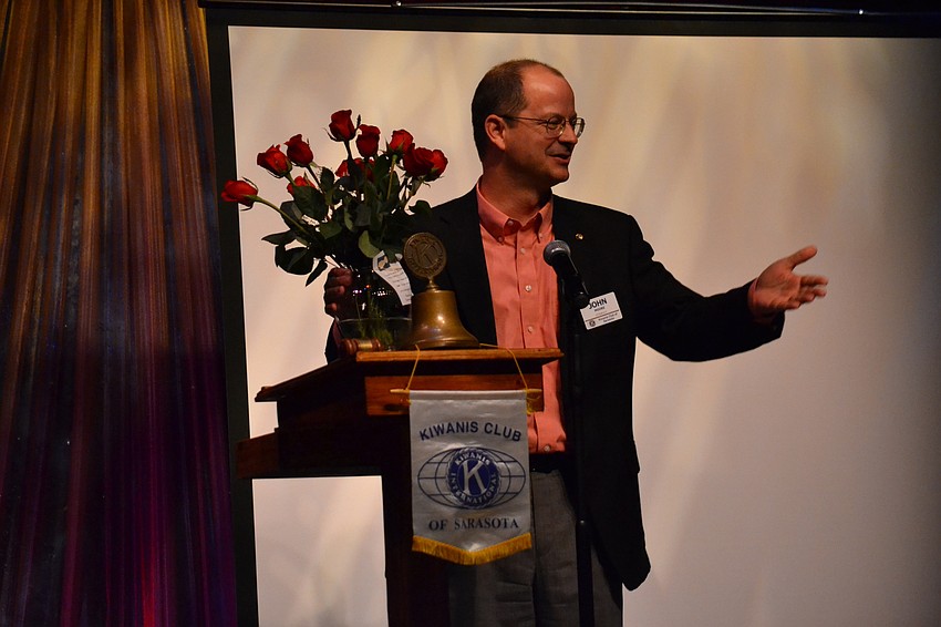Kiwanis Club of Sarasota President John Moore auctions off a bouquet of roses for Mother’s Day.