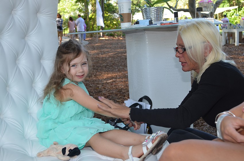 Valya Taylor has a glitter tattoo applied by LJ