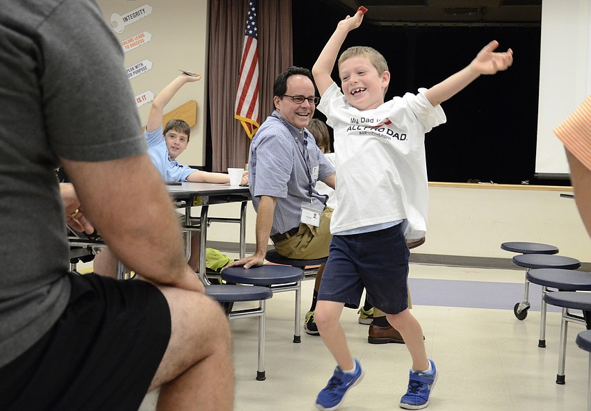 Peyton Gray, a kindergartener, dances back to his seat after winning the All-Pro Dad Breakfast raffle for a t-shirt.