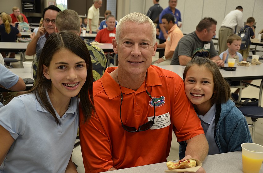 Fifth-grader Presley Long, left, and third-grader Zoey Long, right, with step-dad Ernest Peeples