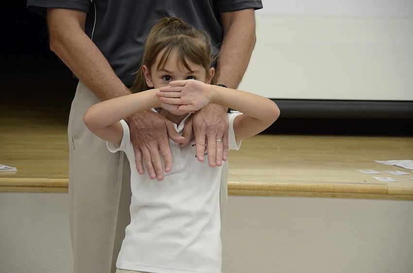 Reese Martin, a first grade student, helps her dad, Steve, as he ran the meeting.