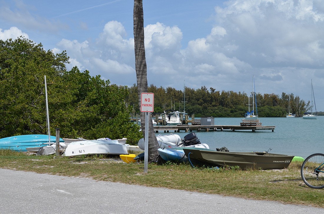 Some Villagers want the town to enforce an ordinance on this piece of town-owned land along Bayside Drive that would force the cleanup of boats that have been stored here for years. File photo
