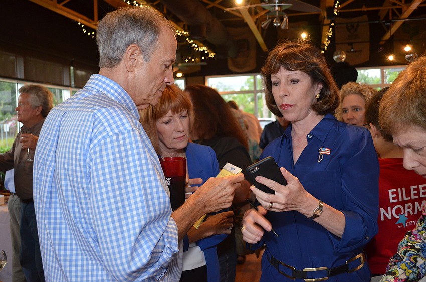 Eileen Normile receives initial results from the polls.