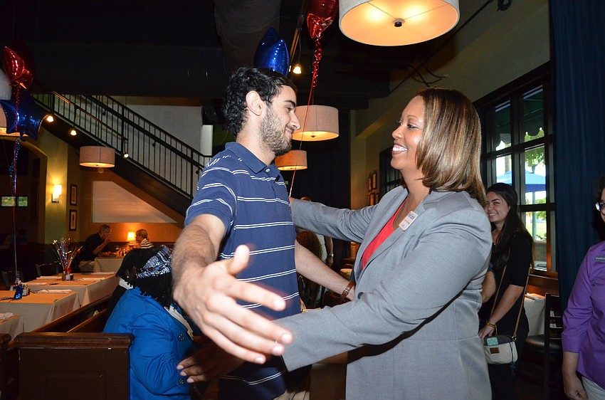 Shelli Eddie hugs campaign manager Zach Morrison after confirming the results that she won.