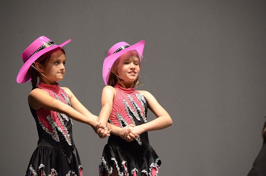 Celeste Wilson and Sadie Kruse, second- and first-grade students at Tara Elementary, do-si-do to I Wanna Be a Cowboy.