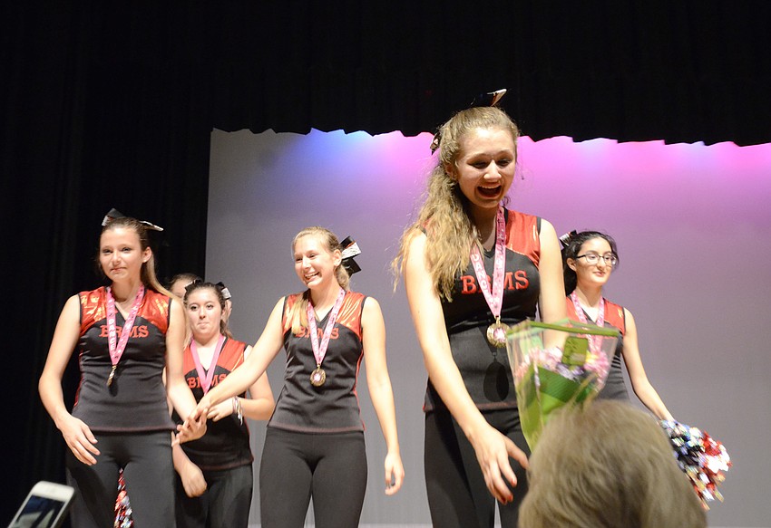 Hayley Veltri tearfully accepts a bouquet from her mother, Mora Veltri, and her grandmother, Carol Goodnight.