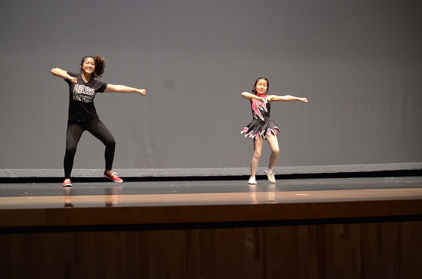 Katie Hang, a 12-grade Braden River High School student, performs a routine with her sister, Haylen, to Break Free.