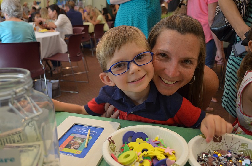 Charlie and Beth Horn decorate a picture frame together.