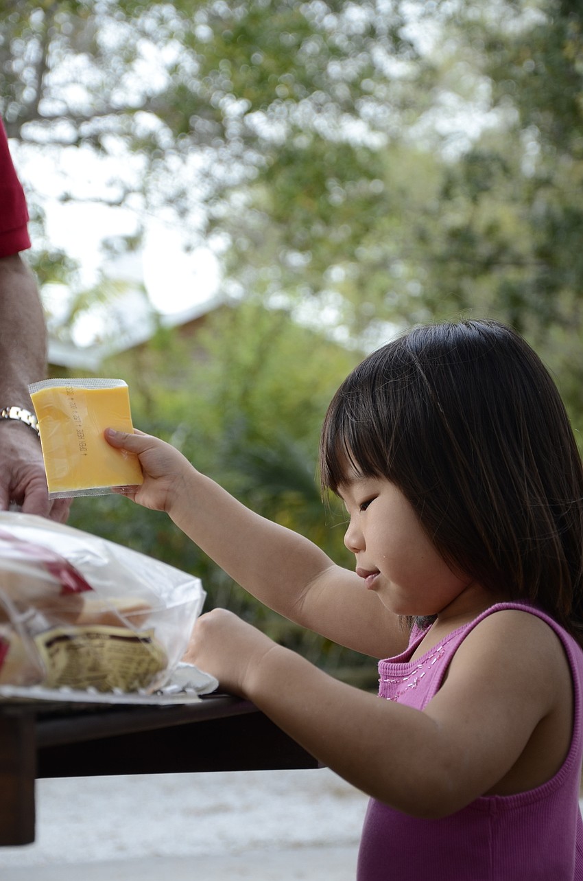 Choe Jane Light, 4, helps her father, Richard, make cheeseburgers.