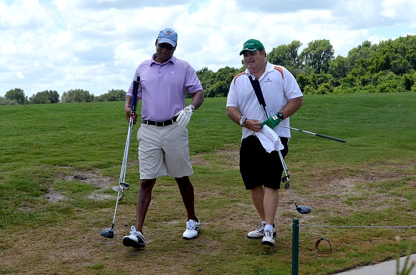 Bryan Ellerson and Bill Gresham head toward their golf cart minutes before the tournament begins.