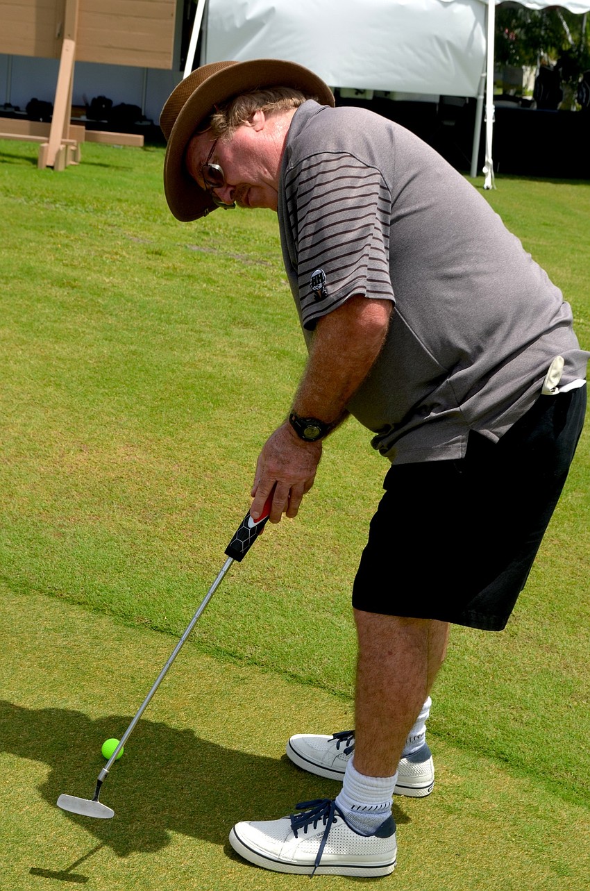 Jeff Van Guilder takes a few practice shots before the tournament.