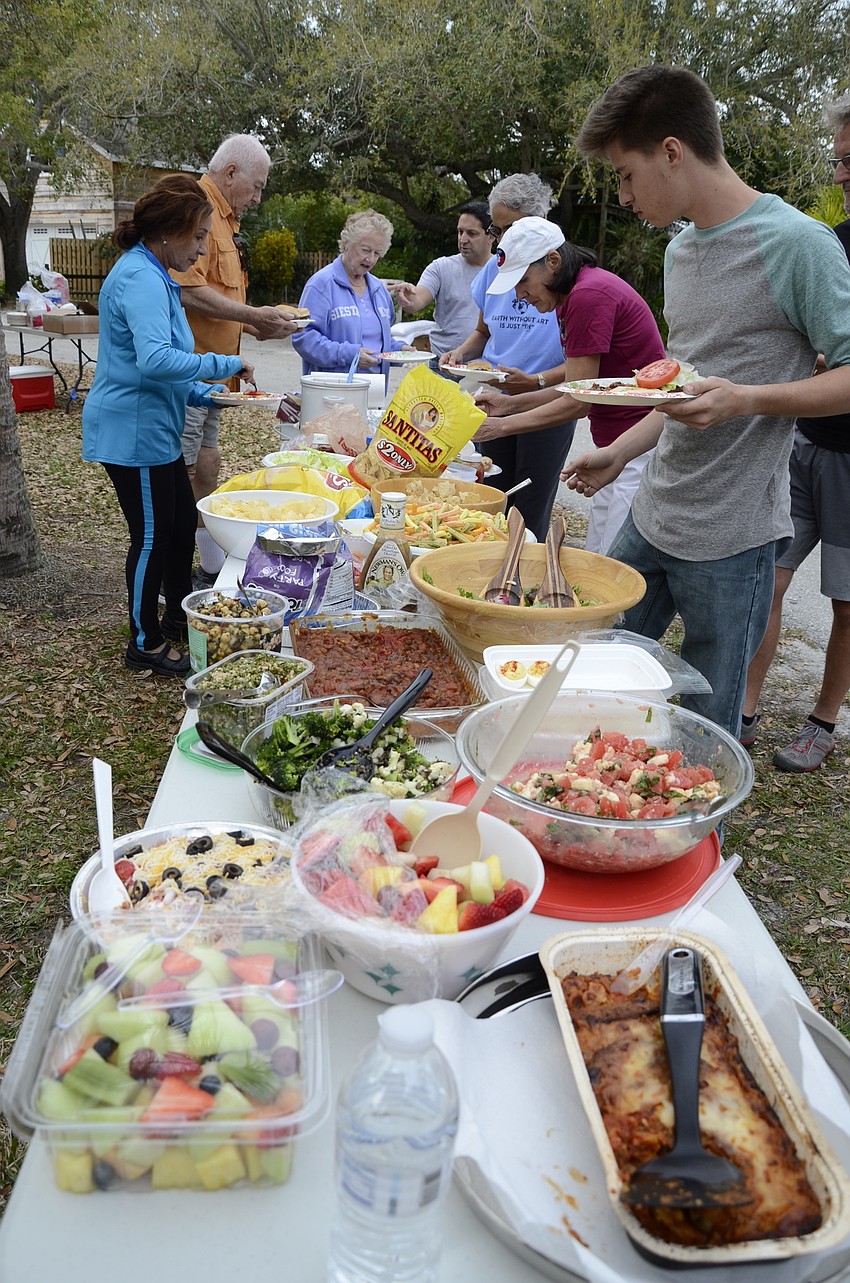 Palm Island residents grab food at the picnic.