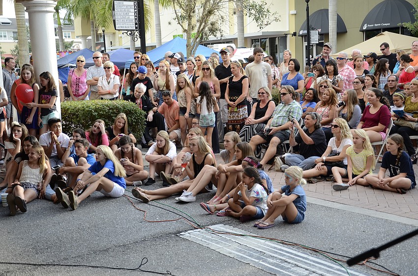 Friends and family watch the choir sing a selection from Wicked.
