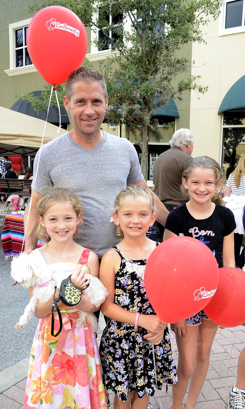 Brooke East, far left, will attend Nolan Middle School in the fall. She came to Nolan Night with her dad, Brian, and her sisters, Addison and Ella, and their dog, Tucker.