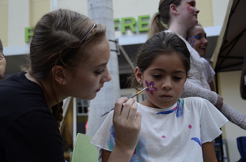 Kylee Mroz, a Nolan eighth grader, paints Olivia Hadad's face.