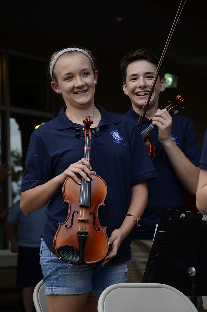 Kerrigan Himmel and Justin Resnick stand after the chamber orchestra performance.