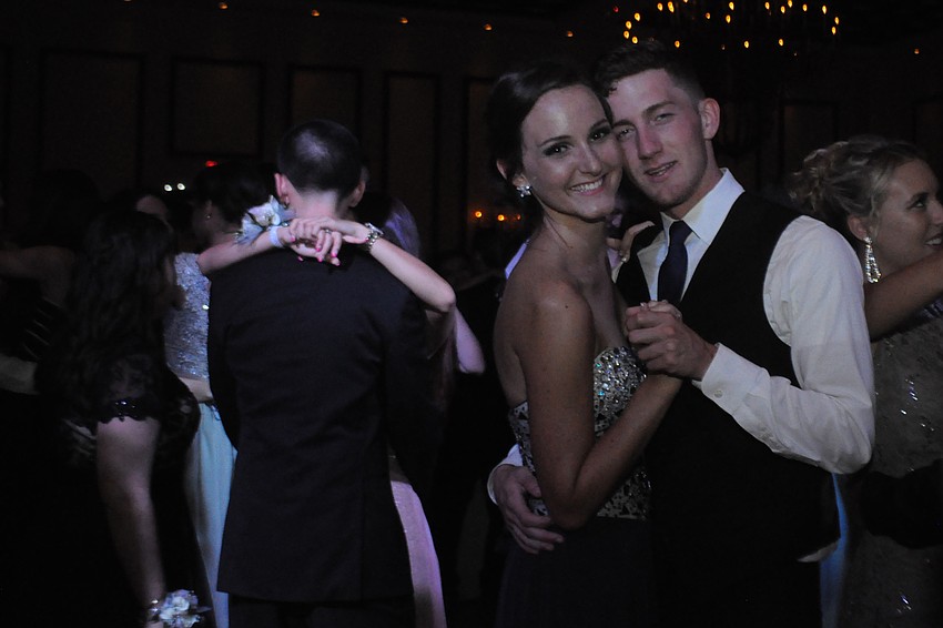 Alyssa Disbro dances with her date, Blake Bluemlein.