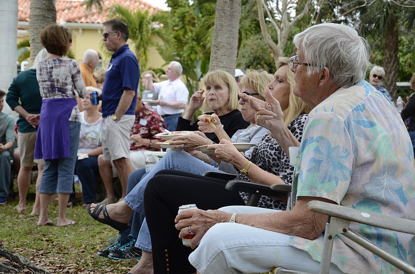Neighbors munched on hamburgers, hot dogs and side dishes at the annual picnic.