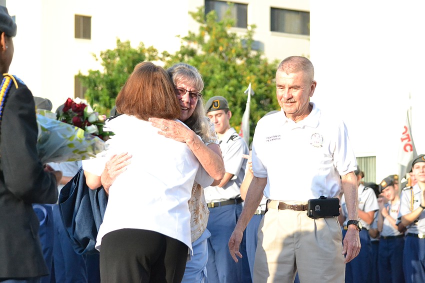 Tootie Kennedy hugs SMA Head of School Christina Bowman alongside Dan Kennedy.