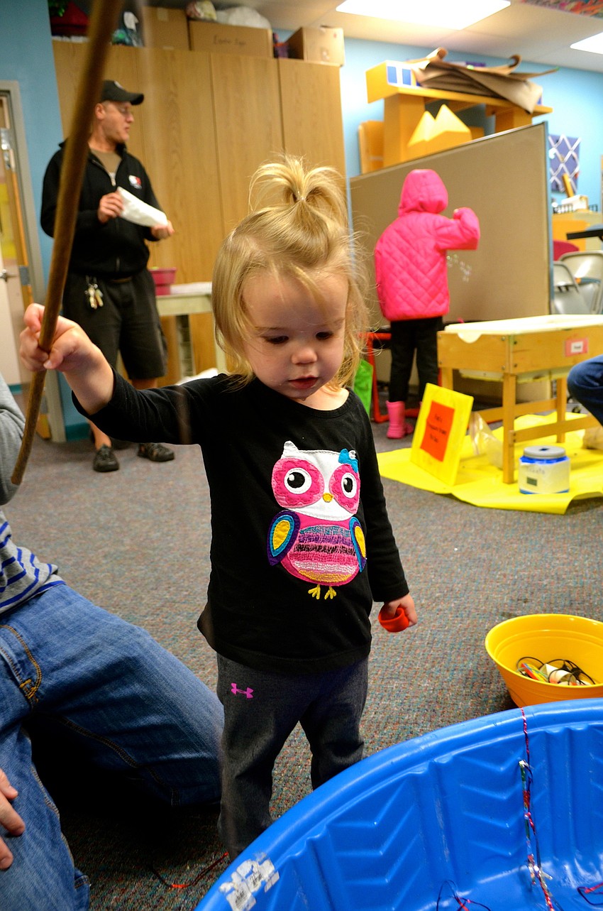 Juliet Chapman looks for fish in the swimming pool pond.