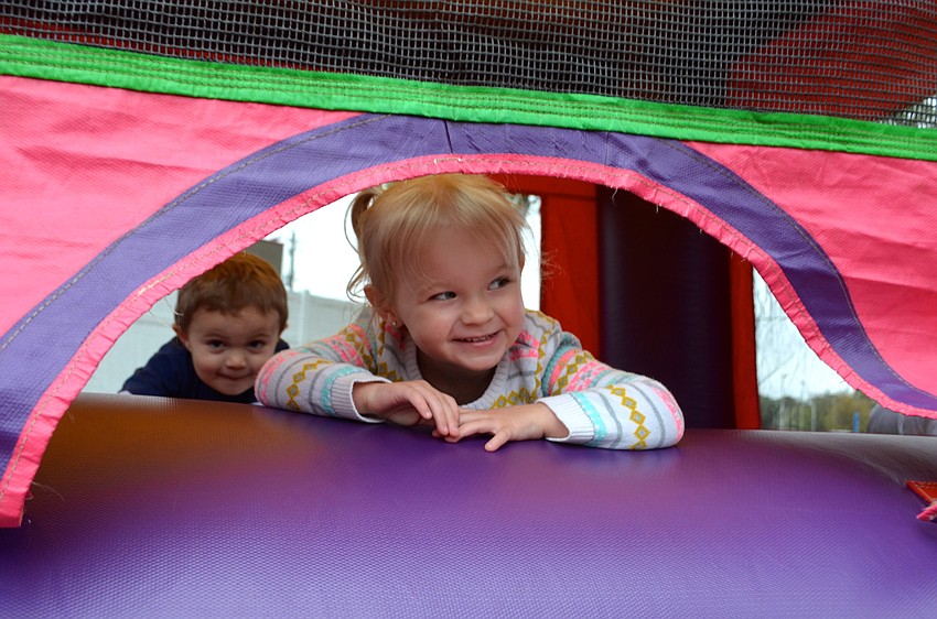 Three-year-old Laya Gunther takes a break from jumping in the bounce house.