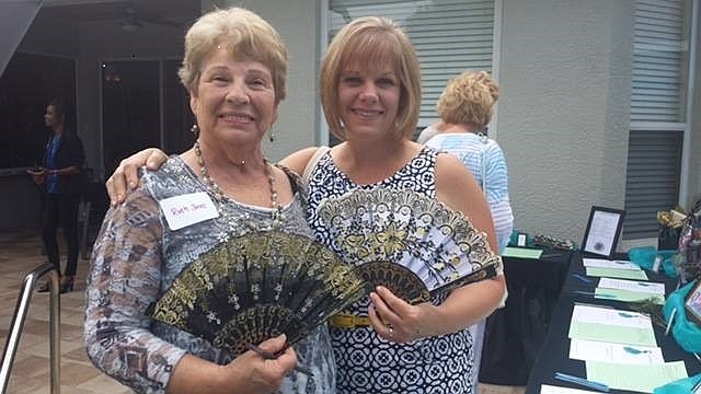 Ruth Jones and her daughter, Allison Cavallaro, show off their fans and matching smiles before having tea and snacks at the â€œProud as a Peacockâ€ annual Ladies Tea. Courtesy photos