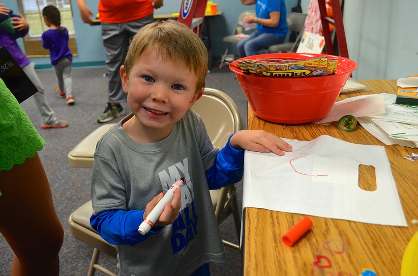 John Hudson, 3, writes his name for his mother.