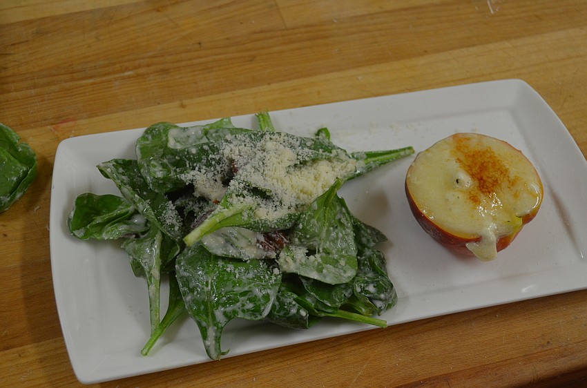 The first course, a spinach salad with a gorgonzola dressing and a brûléed, bleu cheese-stuffed peach topped with Spice & Tea’s bonita peach rooibos herbal tea
