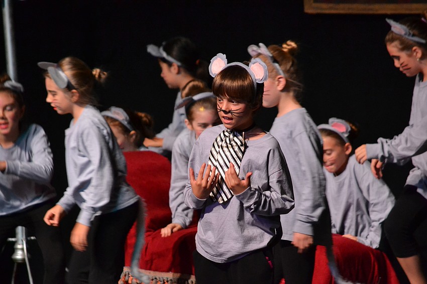Students dressed as mice help Cinderella with chores and prepare for the ball.