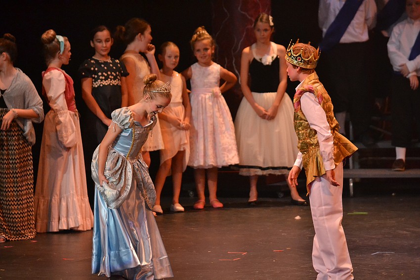 Cinderella and Prince Charming meet at the royal ball played by Ella Wicks and Nick Rich, respectively.