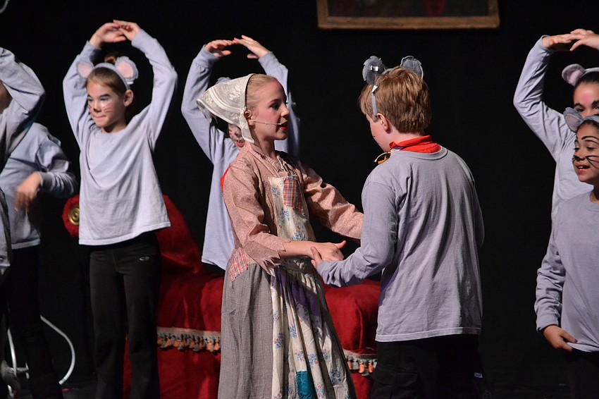 Ella Wicks as Cinderella is consoled by her mice friend.