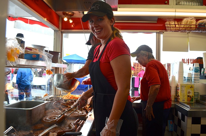 Katie Greene, of Kate’s Diner, cooks up sausages for her guests.