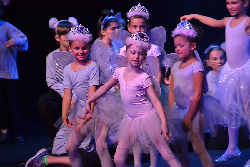 Fairies flood the stage to signal the arrival of Cinderella's fairy godmother.