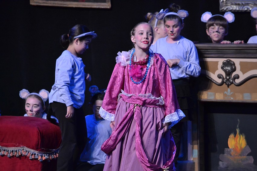 Cinderella tries on the gown made by her mice friends.